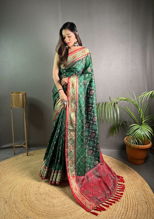 dark Green Soft Rangeen Patola Silk Saree with All-Over Meenakari Weaving, Rich Pallu, and Tassels – Includes Unstitched Blouse Piece.