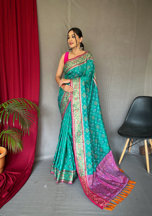 Green Color Soft Rangeen Patola Silk Saree with All-Over Meenakari Weaving, Rich Pallu, and Tassels – Includes Unstitched Blouse Piece.