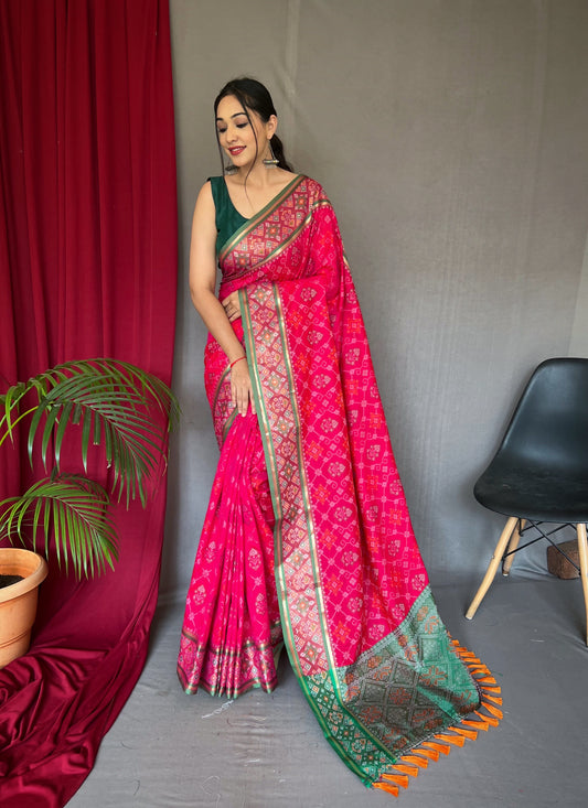 Pink Color Soft Rangeen Patola Silk Saree with All-Over Meenakari Weaving, Rich Pallu, and Tassels – Includes Unstitched Blouse Piece.