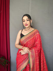 Red Color Pure Patola Silk Saree with Patola Fusion Design, Contrast Meenakari Work, Rich Pallu with Tassels – Includes Unstitched Blouse Piece.