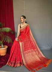 Red Color Pure Patola Silk Saree with Patola Fusion Design, Contrast Meenakari Work, Rich Pallu with Tassels – Includes Unstitched Blouse Piece.