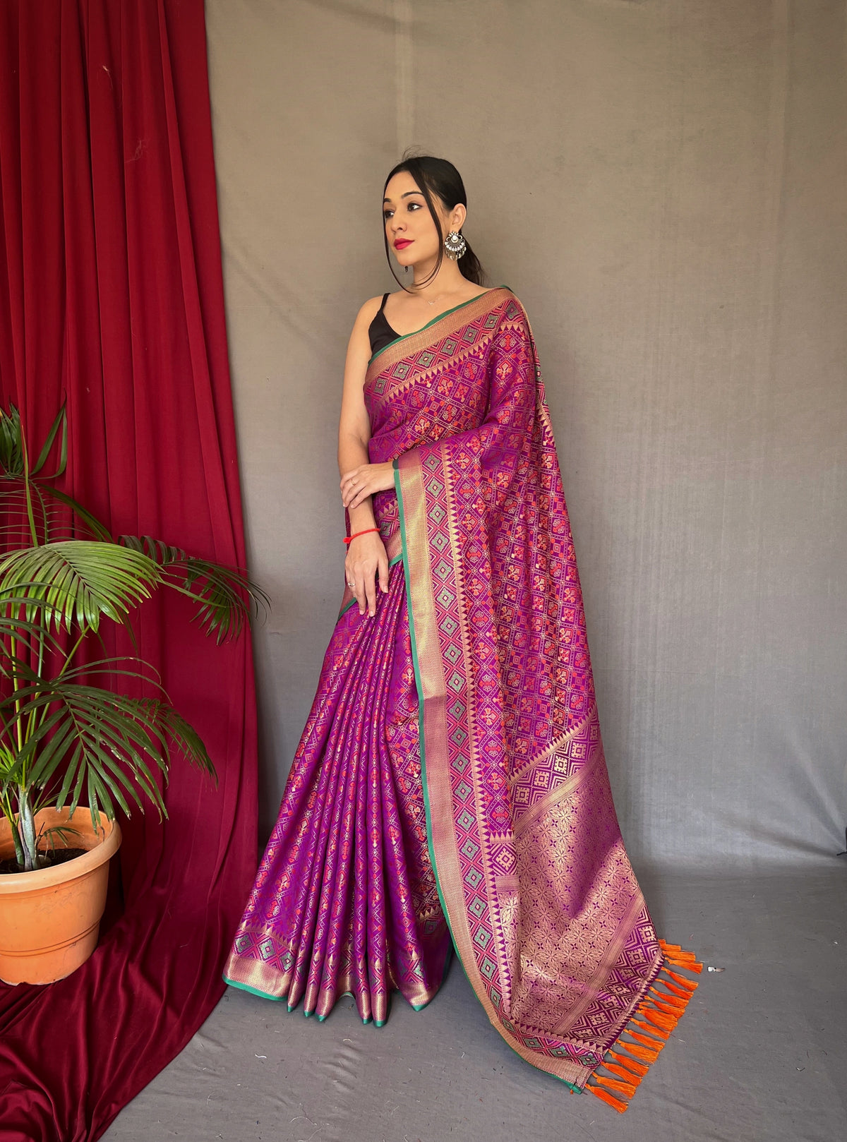 Wine Color Pure Patola Silk Saree with Patola Fusion Design, Contrast Meenakari Work, Rich Pallu with Tassels – Includes Unstitched Blouse Piece.