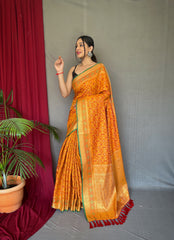 Yellow Color Pure Patola Silk Saree with Patola Fusion Design, Contrast Meenakari Work, Rich Pallu with Tassels – Includes Unstitched Blouse Piece.