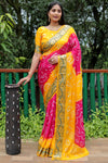 Luxurious Yellow Dual Colour Bandhej Silk Saree with Zari Weaving and Broad Border – Soft, Lightweight, and Stylish.